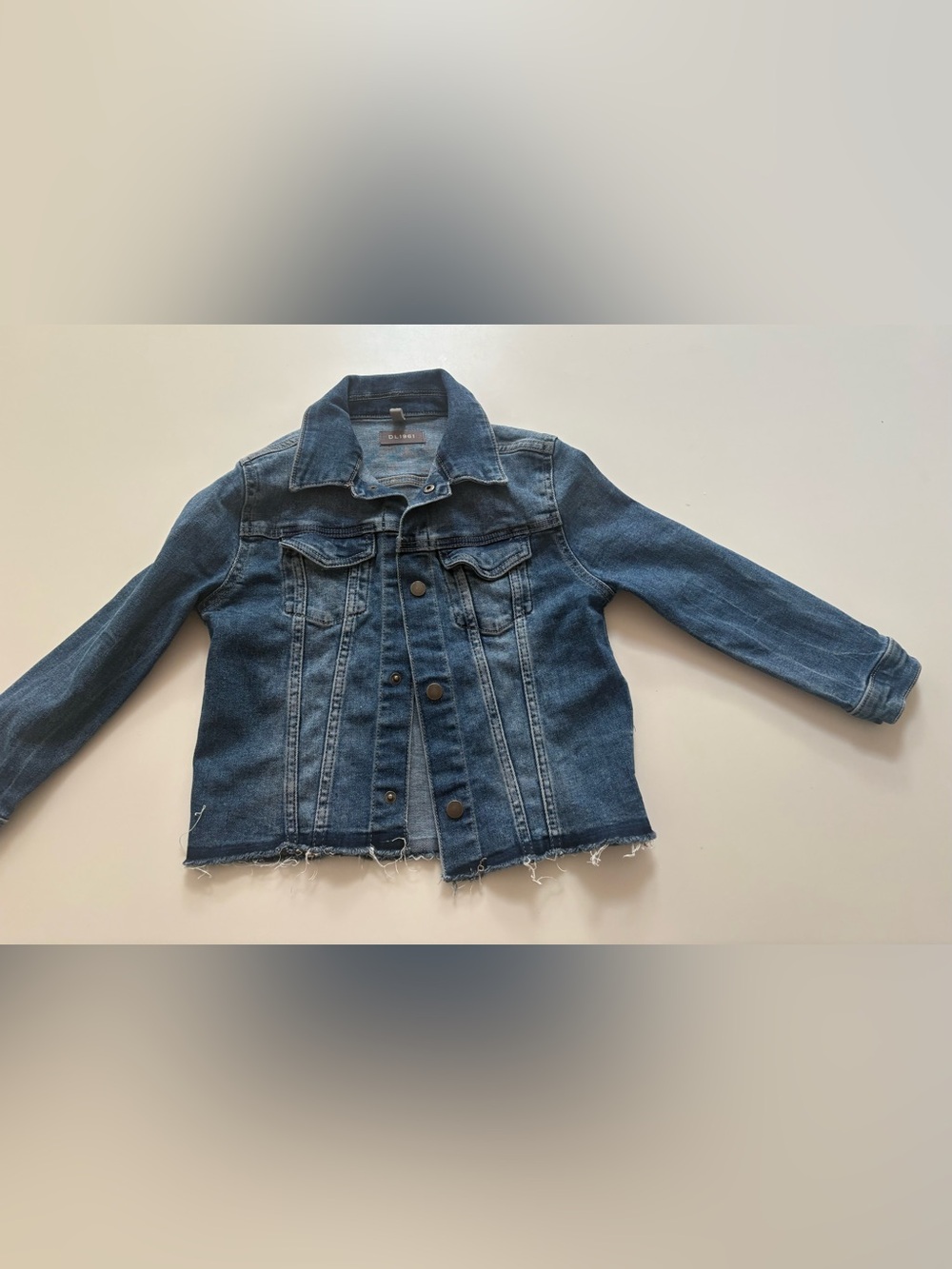 DL1961 Girls' Manning jean jacket features a dark wash and a frayed